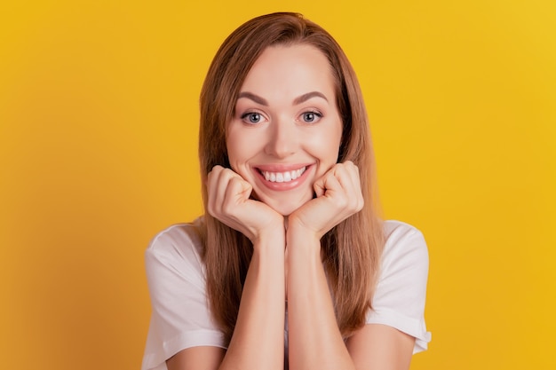 Close-up portrait of charming pretty lady toothy smile hands cheeks