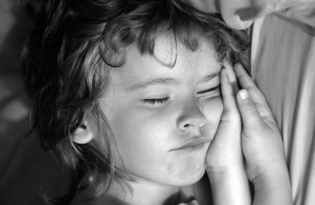 Photo close up portrait of child little boy sleeps in the bed on pillow concept of kids sleeping