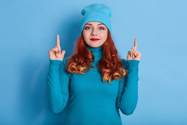 Close up portrait of clever red haired woman with curls