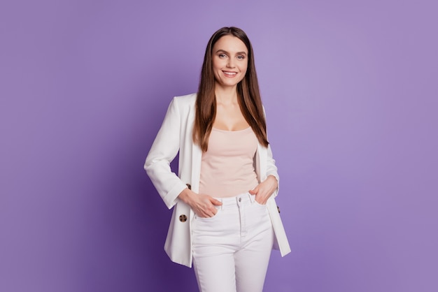 Close up portrait of confident boss lady hands pockets wear formal suit posing on purple wall