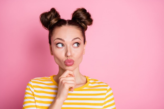 Close-up portrait of creative minded girl touching chin overthinking 