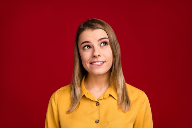 Close-up portrait of curious blond cheerful dreamy girl wearing yellow blouse creating idea