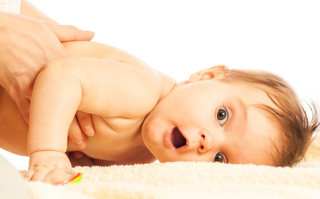 Close-up portrait of a curious little pretty girl lying on a divan