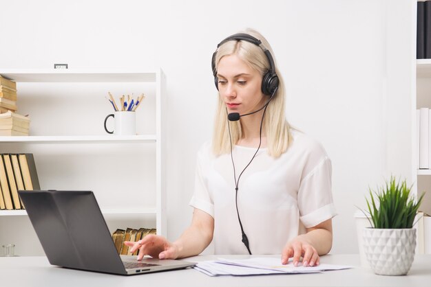 Close-up portrait of a customer service agent sitting at office