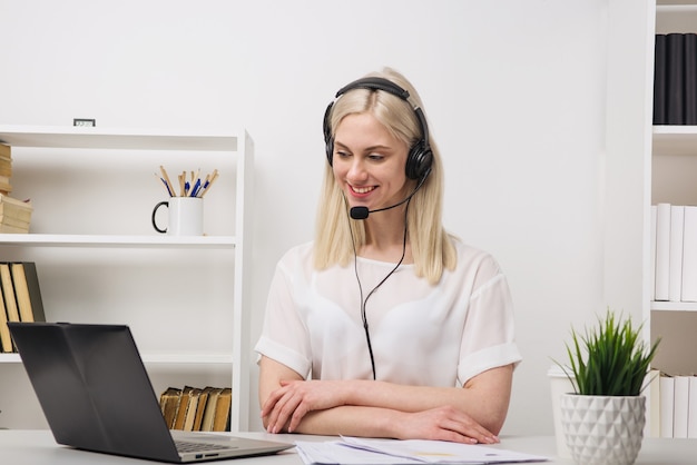 Close-up portrait of a customer service agent sitting at office