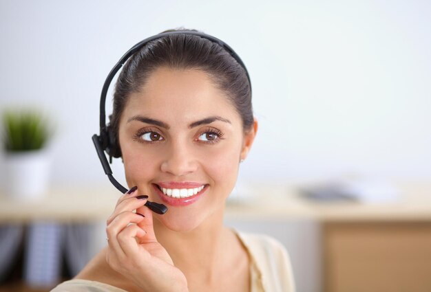 Close-up portrait of a customer service agent sitting at office