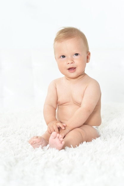 Close up portrait of cute beautiful baby boy on bed