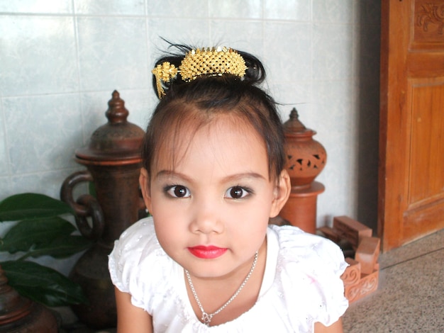 Close-up portrait of cute girl at home