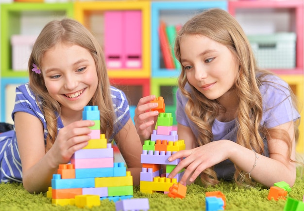 close up portrait of cute girls playing together