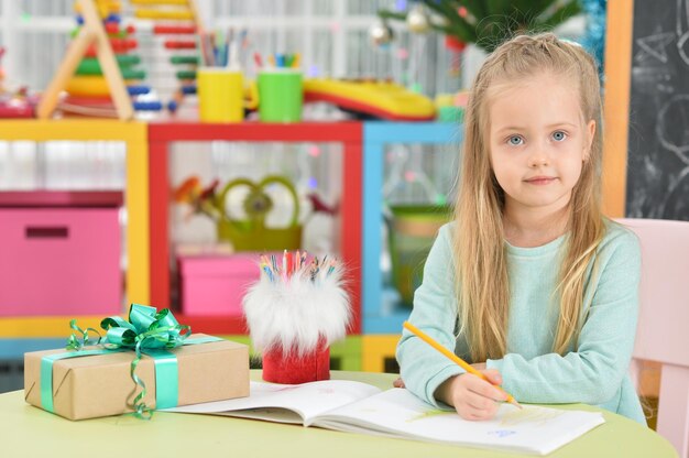 Close up portrait of cute smiling girl drawing