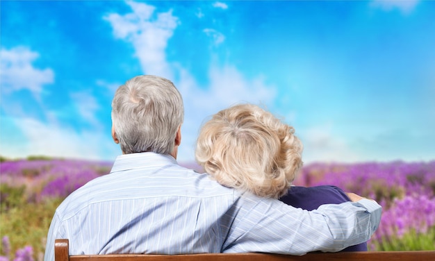 Close-up portrait of an elderly couple hugging in park