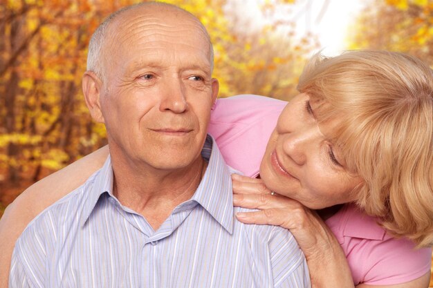 Close-up portrait of an elderly couple hugging