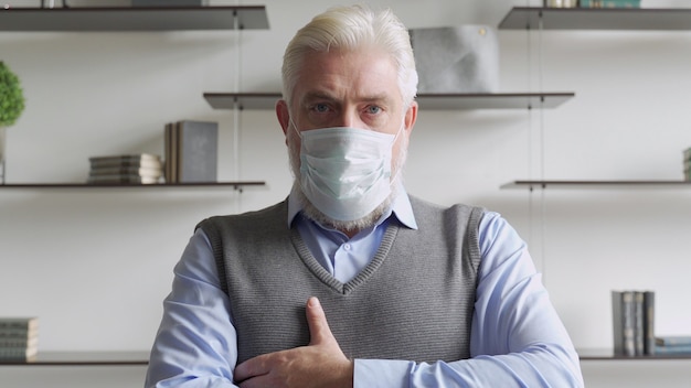 Close up portrait of elderly man in medical face mask