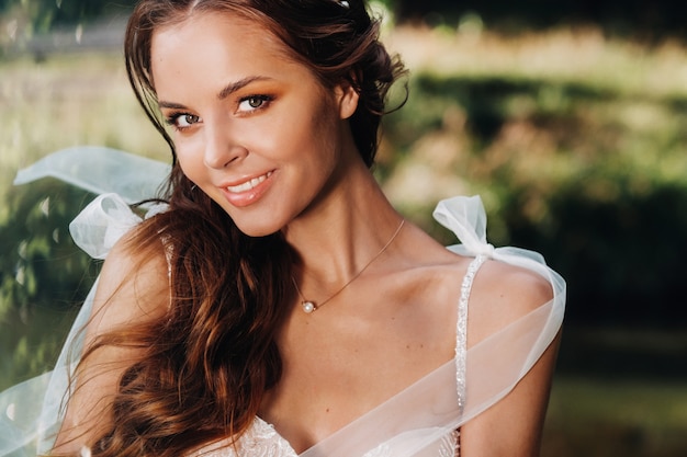 Close-up portrait of an Elegant bride in a white dress in nature in a nature Park.Model in a wedding dress and gloves .Belarus