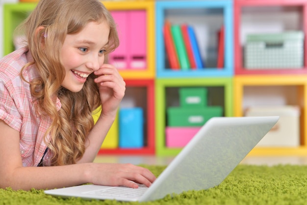 Close up portrait of emotional cute girl using laptop