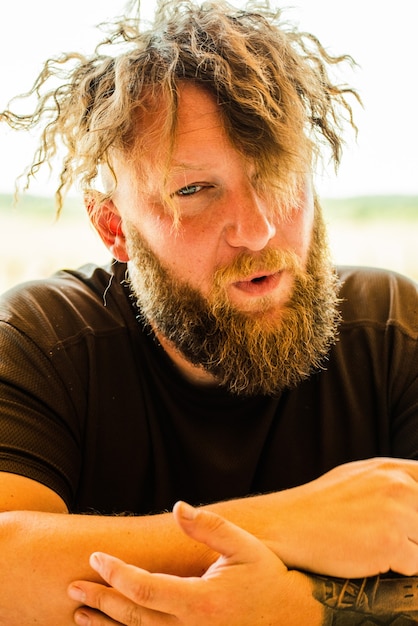 Close up portrait of fashionable redhead hipster man with fuzzy beard