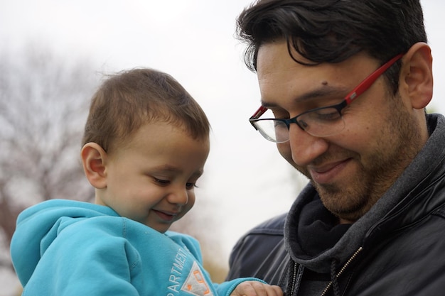 Close-up portrait of father and son