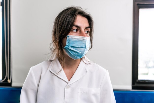 Close up portrait of female scientist wearing face mask in the laboratory