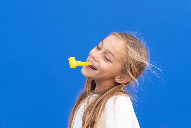 Close-up portrait of a girl against blue background