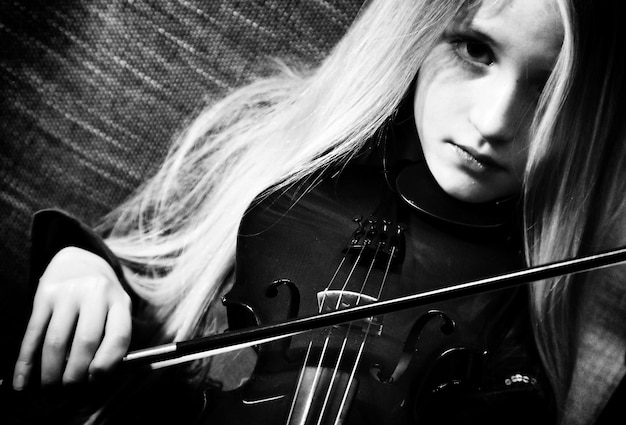 close-up portrait of girl playing violin