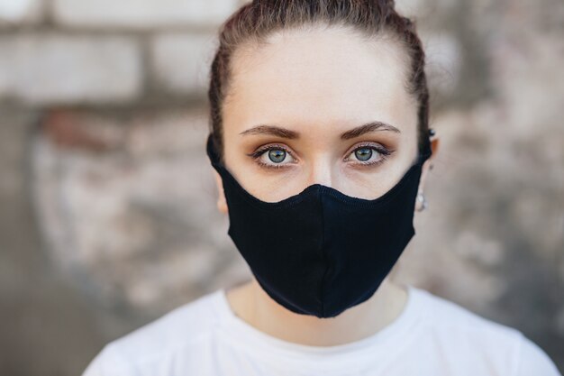 A close-up portrait of a girl in a protective mask