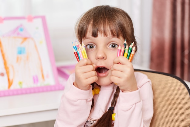Close up portrait of girl with art supplies
