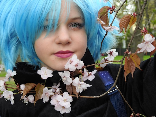 Close-up portrait of girl with blue hair in park