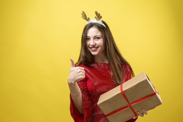 Close-up portrait of a girl with gifts in her hands.