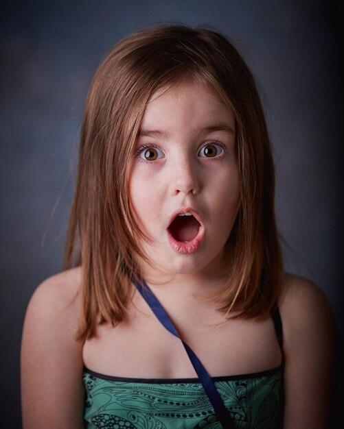 Close-up portrait of girl with mouth open