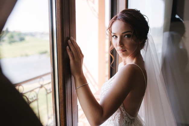 Close up portrait of gorgeous bride at hotel in morning. 