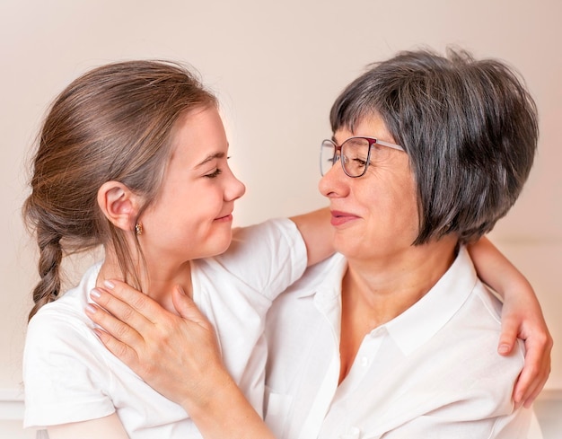 close-up portrait of grandmother and granddaughter