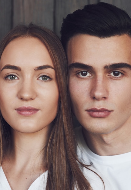 Close up portrait of half faces man and woman looking at camera