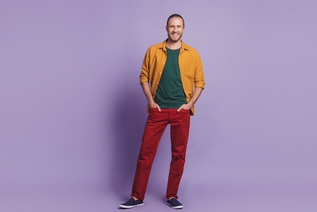 Close up portrait of handsome confident guy posing hands pockets