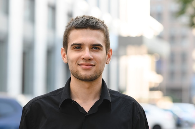 Close up portrait of a handsome young man in a black shirt