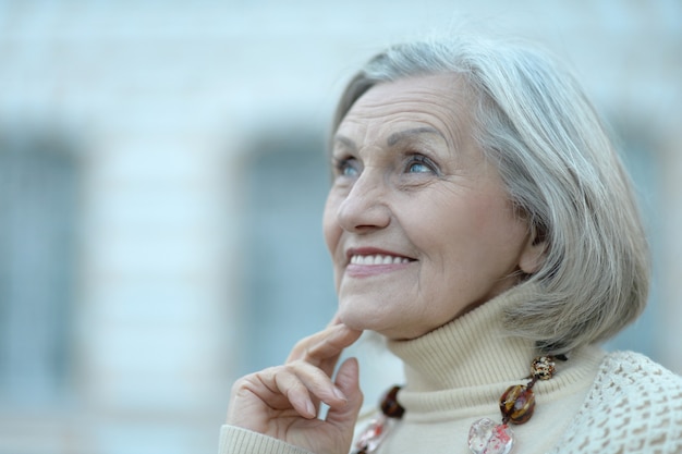 Close up portrait of happy beautiful senior woman outdoor