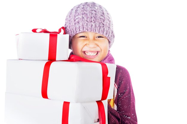 Close-up portrait of happy girl with gifts against white background