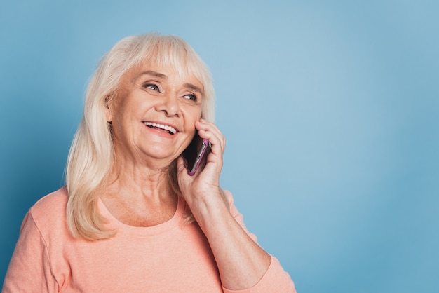 Close up portrait of happy mature woman talking on smartphone