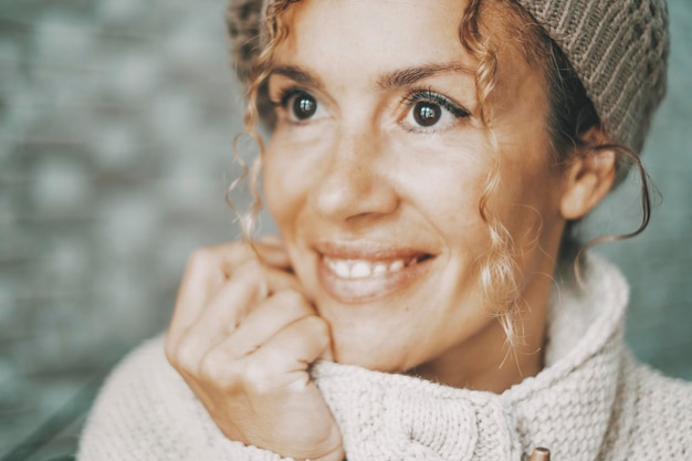 Close up portrait of happy mature woman with dreamer expression on face Eye on focus One female people smiling and looking in front of her with serene attitude Concept of joy lady enjoying alone