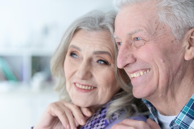 Close up portrait of happy senior couple posing at home