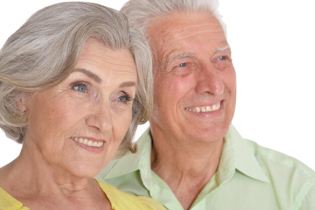 Close up portrait of happy senior couple posing on white background