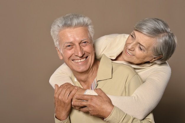 Close-up portrait of a happy senior couple on white background