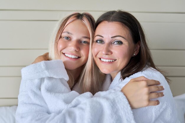 Close up portrait of happy smiling mom and teenage daughter Family relationship parent child teenager