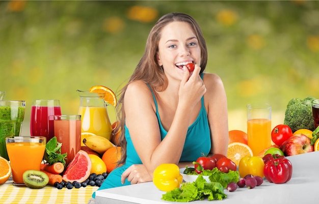 Close-up portrait of happy young woman with fruits