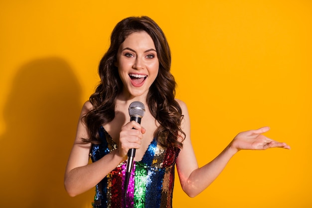 Close-up portrait of her she-looking attractive lovely charming cheerful cheery wavy-haired girl singing single spending free time hobby isolated bright vivid shine vibrant yellow color background