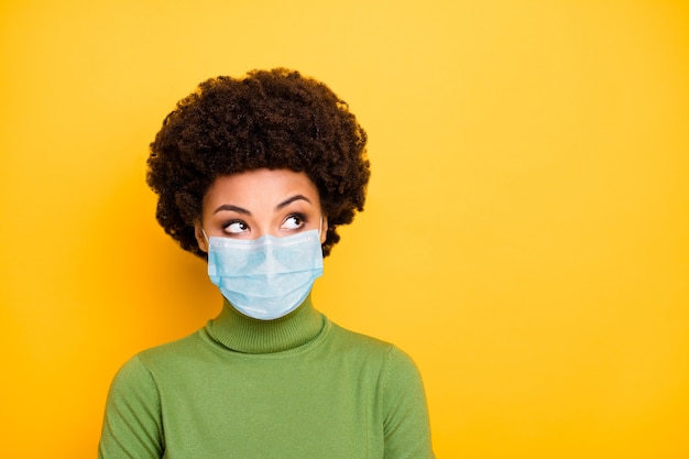 Close-up portrait of her she minded wavy-haired girl wearing safety mask mers cov pandemia thinking deciding viral 2019 ncov contamination isolated vivid bright vibrant shine yellow color background