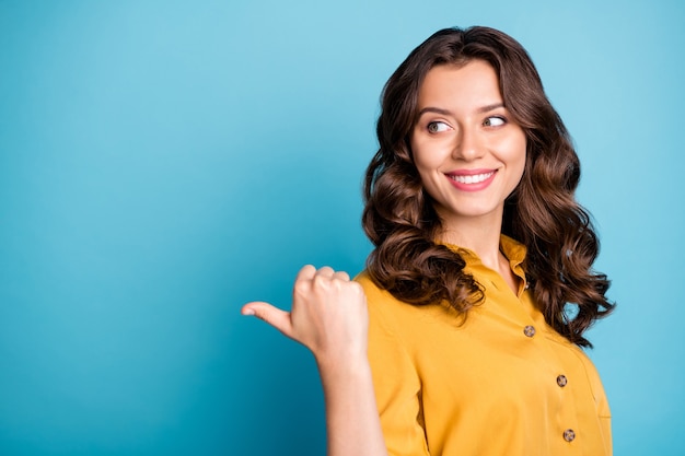 Close-up portrait of her she nice attractive charming confident cheerful cheery wavy-haired girl showing thumb aside ad .