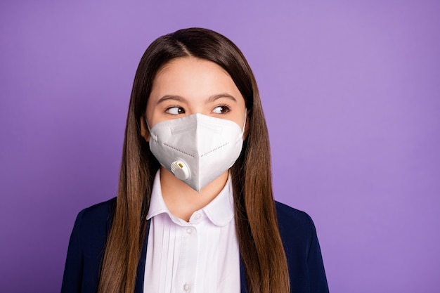 Close-up portrait of her she nice attractive long-haired schoolchild wearing n95 safety mask respirator mers cov prevention co2 air pollution thinking isolated on violet lilac purple color background