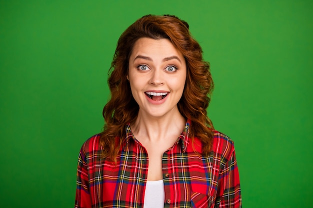 Close-up portrait of her she nice attractive lovely pretty amazed cheerful cheery wavy-haired girl wearing checked shirt great news isolated over bright vivid shine vibrant green color background