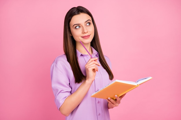 Close-up portrait of her she nice attractive lovely pretty brainy intellectual focused cheerful dreamy long-haired girl writing creating notes isolated on pink pastel color background