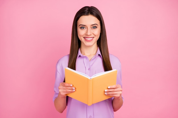 Close-up portrait of her she nice attractive lovely pretty charming cheerful cheery long-haired girl reading science fiction isolated on pink pastel color background